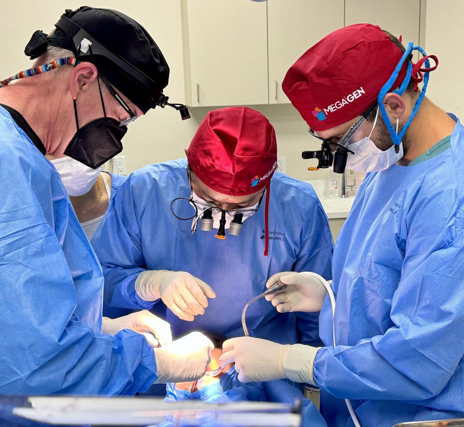 Dentists performing supervised live implant surgery at Brighter Way